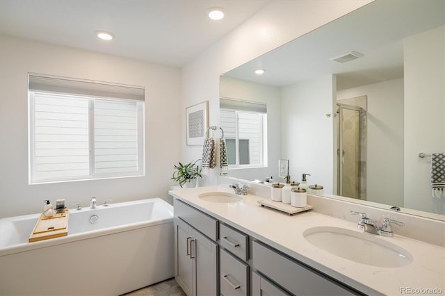 16568 W 92nd Pl, Arvada, CO 80007 - full bath featuring double vanity, a stall shower, a bathtub, and recessed lighting