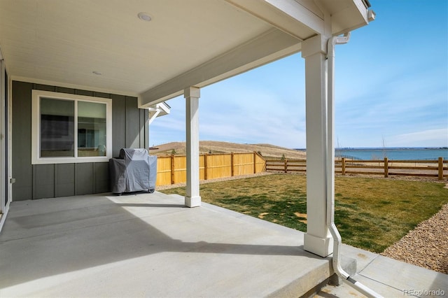 16568 W 92nd Pl, Arvada, CO 80007 - fenced backyard featuring grilling area, a water view, and a patio