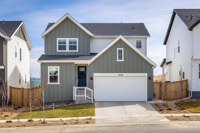 16568 W 92nd Pl, Arvada, CO 80007 - view of front of property with board and batten siding, concrete driveway, a shingled roof, and a garage