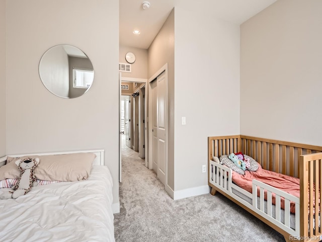 carpeted bedroom with baseboards and visible vents