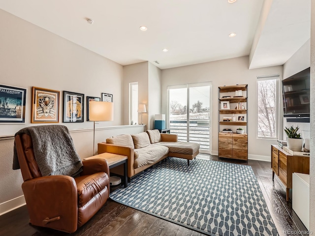 living area with recessed lighting, wood-type flooring, and baseboards
