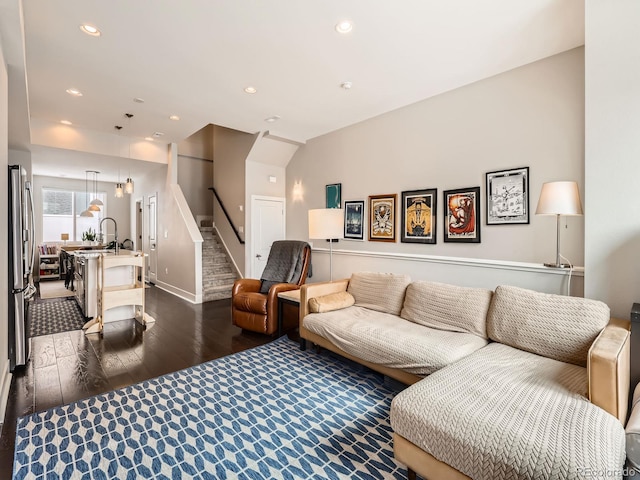 living room featuring recessed lighting, stairs, and dark wood-style floors