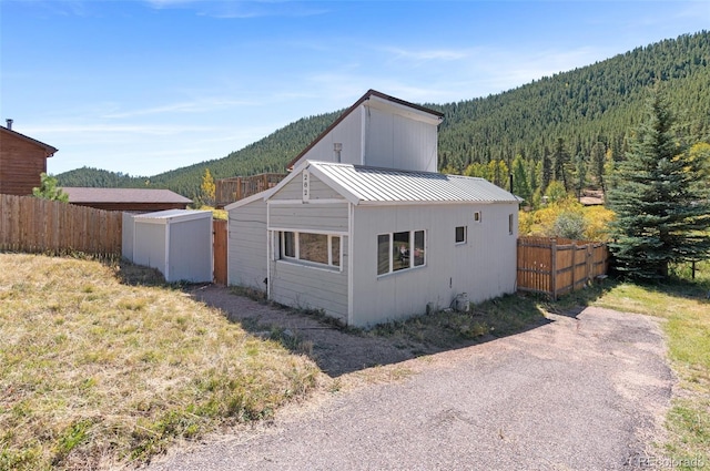 exterior space featuring a shed and a mountain view