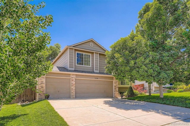 5534 S Wenatchee St, Aurora, CO 80015 - view of front of house featuring brick siding, driveway, and a garage