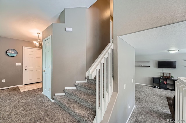 5534 S Wenatchee St, Aurora, CO 80015 - stairway with carpet floors and a chandelier
