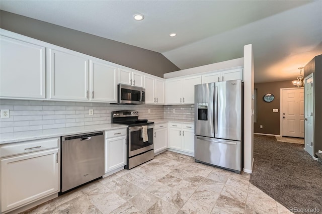 5534 S Wenatchee St, Aurora, CO 80015 - kitchen with appliances with stainless steel finishes, white cabinetry, backsplash, vaulted ceiling, and a chandelier