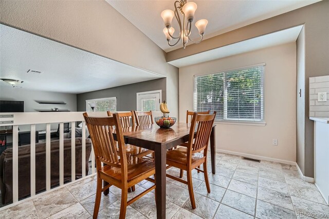 5534 S Wenatchee St, Aurora, CO 80015 - dining area featuring a chandelier and stone tile flooring
