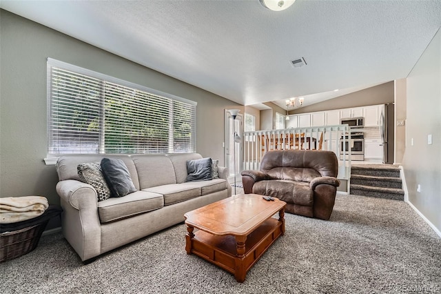 5534 S Wenatchee St, Aurora, CO 80015 - carpeted living room featuring lofted ceiling, a chandelier, and a textured ceiling