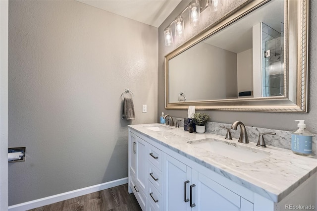 5534 S Wenatchee St, Aurora, CO 80015 - full bath featuring double vanity, wood finished floors, and a textured wall