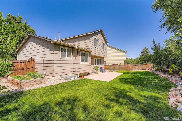 5534 S Wenatchee St, Aurora, CO 80015 - rear view of house with a vegetable garden and a patio area