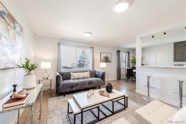 1476 W Dakota Ave, Denver, CO 80223 - living area featuring light wood-style floors and baseboards