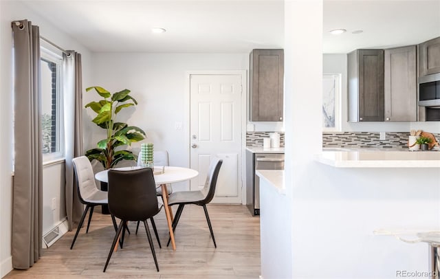 1476 W Dakota Ave, Denver, CO 80223 - dining area with light wood-style floors and recessed lighting