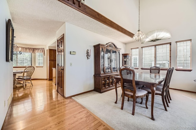 6726 Taft Cir, Arvada, CO 80004 - dining space with light wood-style floors, a chandelier, baseboards, and a textured ceiling