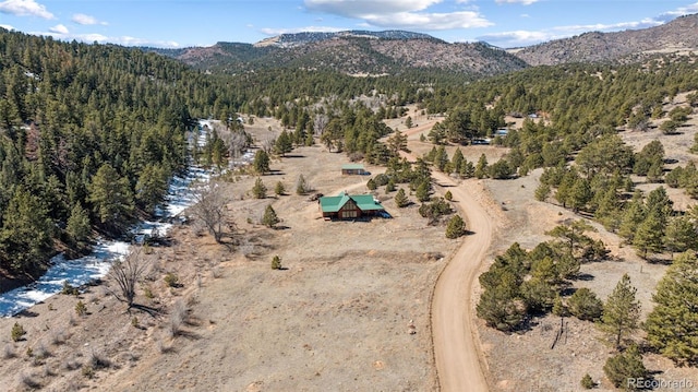2555 New Mill Gulch Rd, Canon City, CO 81212 - view of property location featuring a mountain backdrop and a forest
