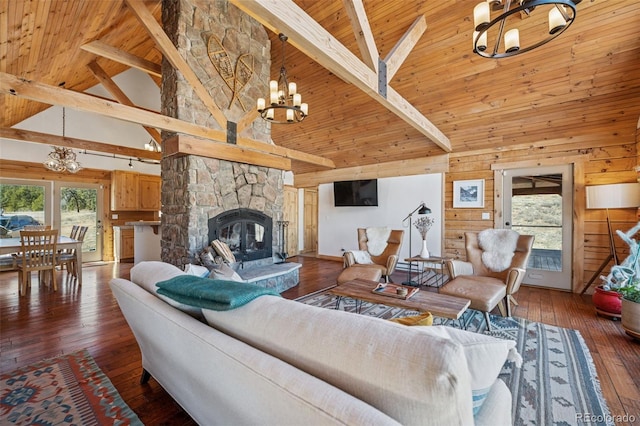 2555 New Mill Gulch Rd, Canon City, CO 81212 - living room with a chandelier, high vaulted ceiling, wooden ceiling with exposed beams, a stone fireplace, and hardwood / wood-style floors