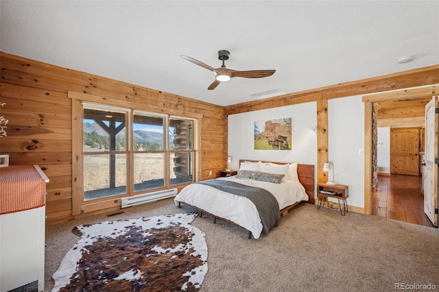 2555 New Mill Gulch Rd, Canon City, CO 81212 - bedroom with a baseboard radiator, wooden walls, carpet flooring, and a ceiling fan