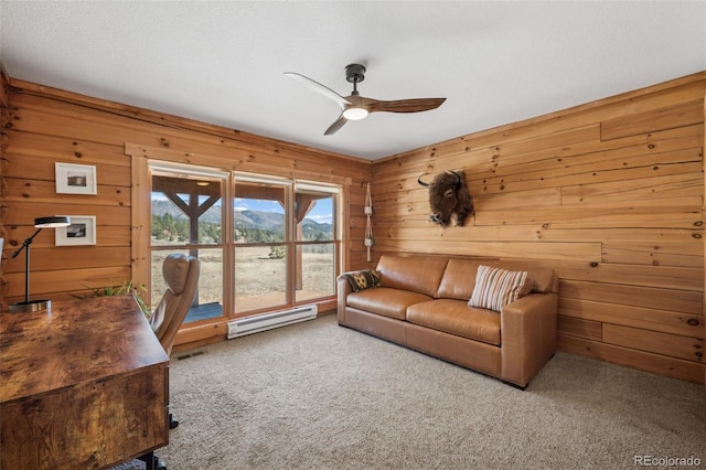 2555 New Mill Gulch Rd, Canon City, CO 81212 - living area featuring baseboard heating, carpet floors, a ceiling fan, and wood walls