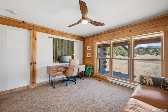 2555 New Mill Gulch Rd, Canon City, CO 81212 - carpeted home office featuring baseboard heating, a ceiling fan, wood walls, and baseboards