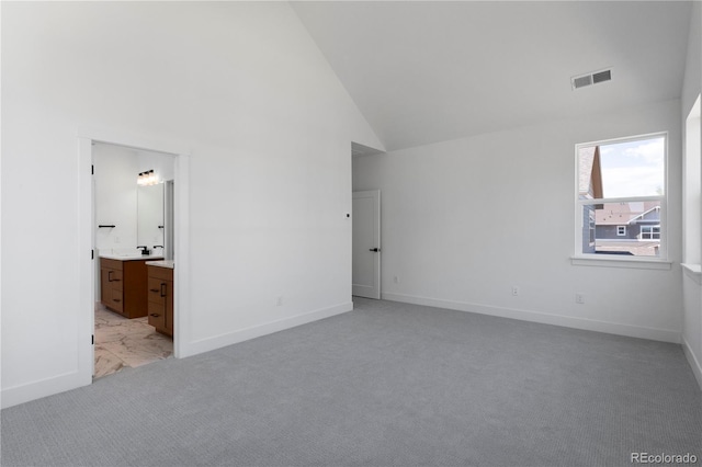 5621 W 141st Ln, Broomfield, CO 80020 - unfurnished bedroom with high vaulted ceiling, light carpet, and ensuite bathroom