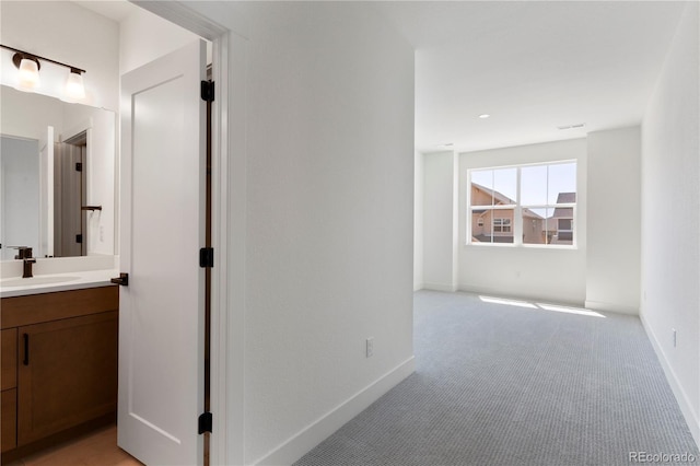 5621 W 141st Ln, Broomfield, CO 80020 - corridor featuring light colored carpet and a sink