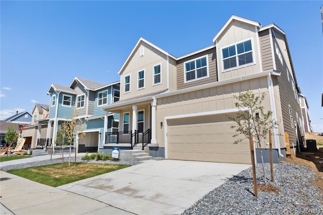 5621 W 141st Ln, Broomfield, CO 80020 - view of front of home featuring board and batten siding, a garage, concrete driveway, a residential view, and a porch