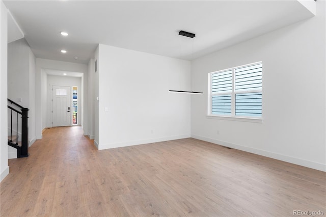 5621 W 141st Ln, Broomfield, CO 80020 - unfurnished room with healthy amount of natural light, stairway, light wood-style floors, and recessed lighting