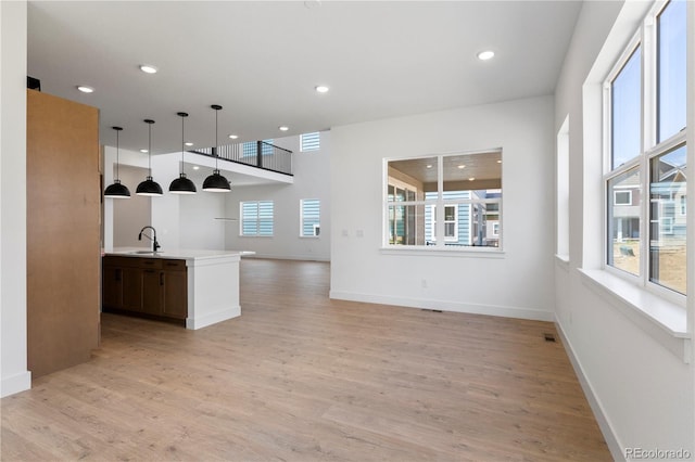 5621 W 141st Ln, Broomfield, CO 80020 - kitchen with light wood-style floors, light countertops, recessed lighting, and pendant lighting