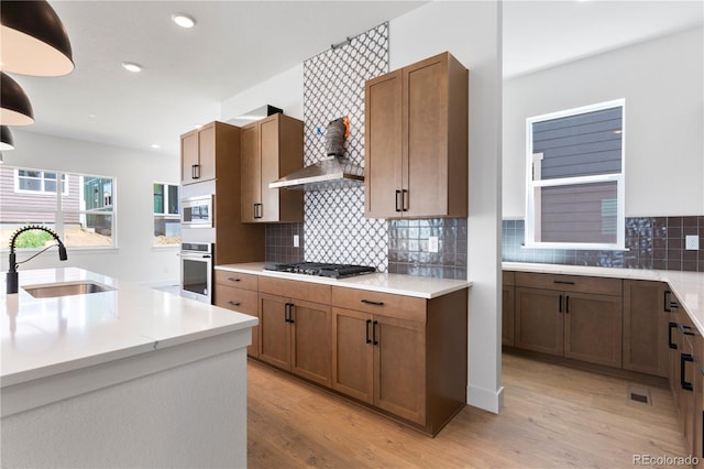 5621 W 141st Ln, Broomfield, CO 80020 - kitchen featuring stainless steel appliances, light wood-type flooring, light countertops, decorative backsplash, and recessed lighting