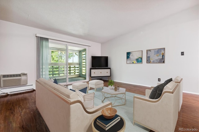 living room featuring an AC wall unit, a baseboard heating unit, baseboards, and wood finished floors