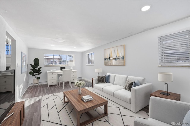 living room with recessed lighting, baseboards, and light wood-style floors