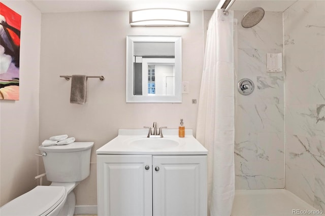 bathroom featuring a marble finish shower, toilet, and vanity