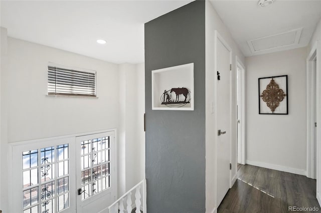 hall with recessed lighting, baseboards, attic access, and dark wood finished floors