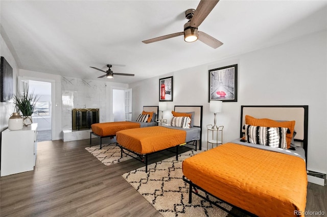 bedroom featuring wood finished floors and baseboard heating