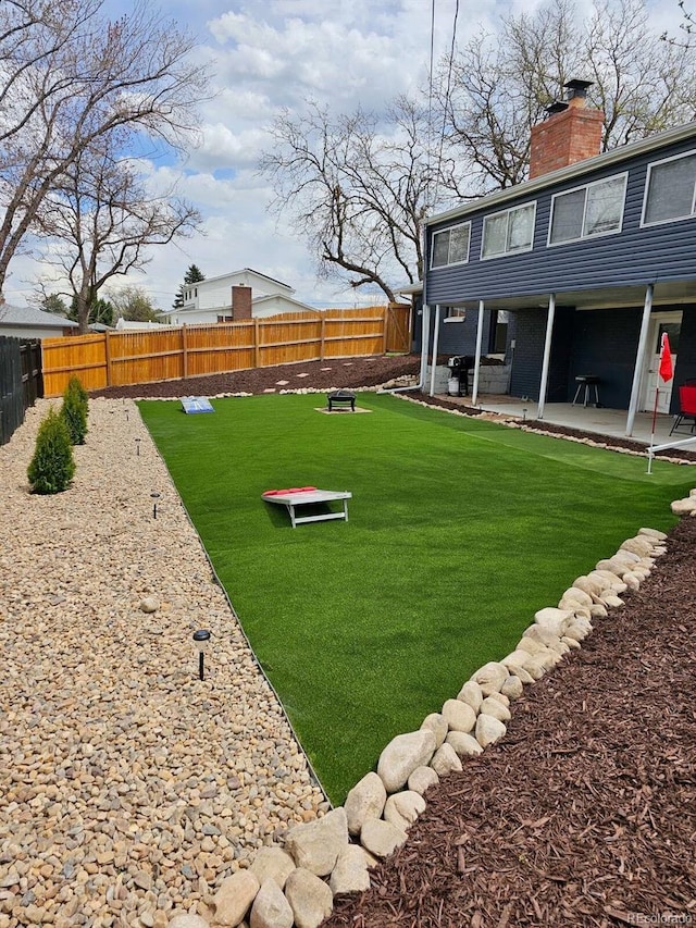 view of yard featuring a patio area and a fenced backyard