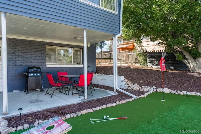 view of patio / terrace featuring grilling area and fence