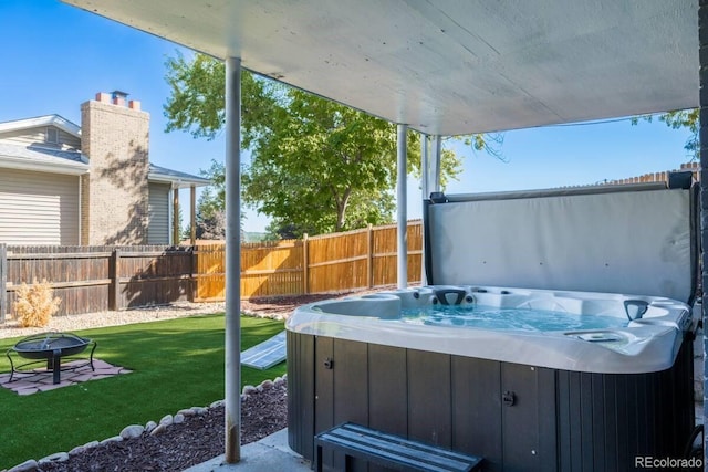 exterior space featuring a hot tub and fence