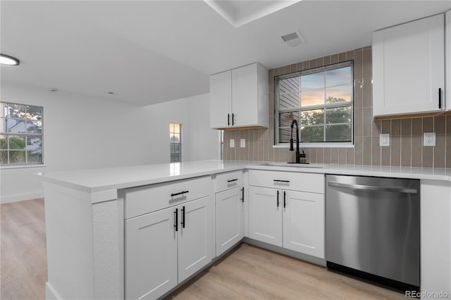 12635 E Pacific Cir Unit A, Aurora, CO 80014 - kitchen featuring dishwasher, a sink, light wood-style floors, a peninsula, and light countertops