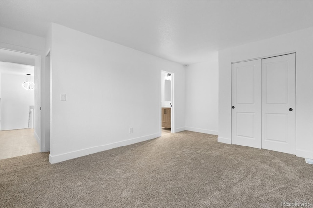 12635 E Pacific Cir Unit A, Aurora, CO 80014 - unfurnished bedroom featuring carpet, a closet, baseboards, and ensuite bathroom