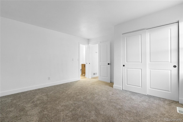 12635 E Pacific Cir Unit A, Aurora, CO 80014 - unfurnished bedroom featuring carpet floors, baseboards, and a closet