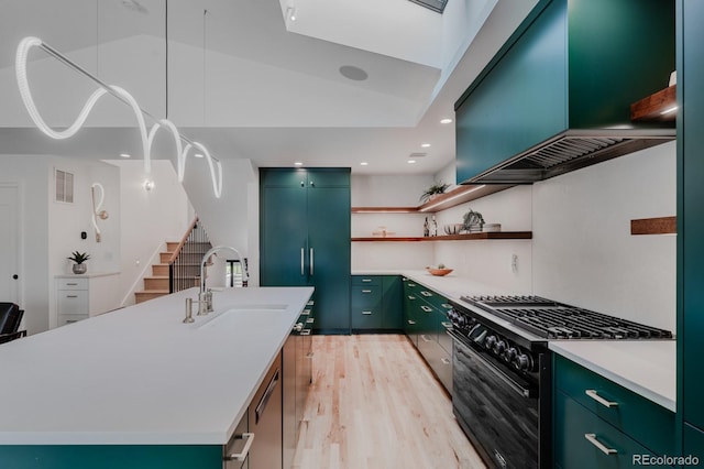 kitchen featuring sink, extractor fan, an island with sink, paneled fridge, and black range with gas stovetop