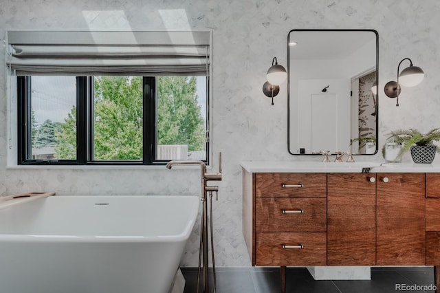 bathroom featuring vanity, tile patterned floors, and a bathtub