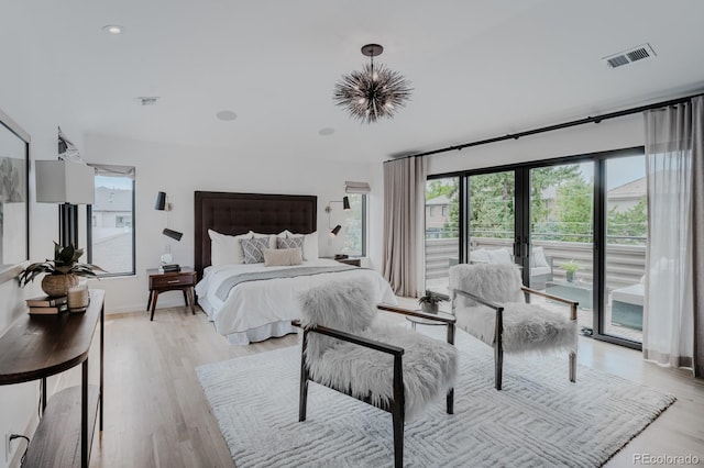 bedroom with french doors, light hardwood / wood-style floors, and access to outside