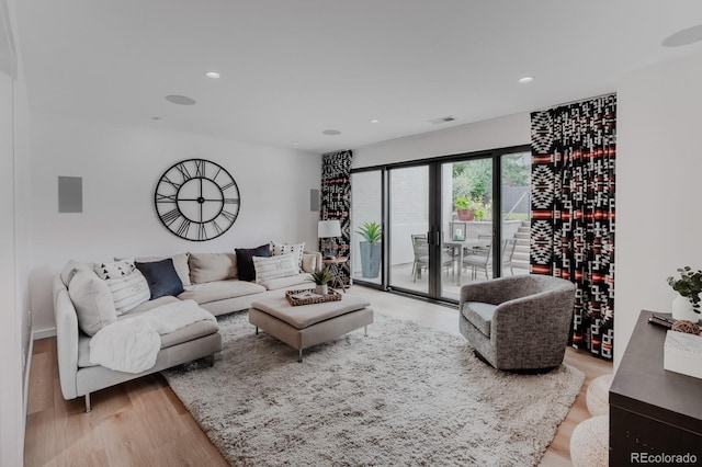 living room featuring french doors and light wood-type flooring