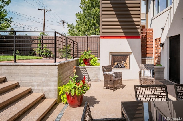 view of patio / terrace with exterior fireplace