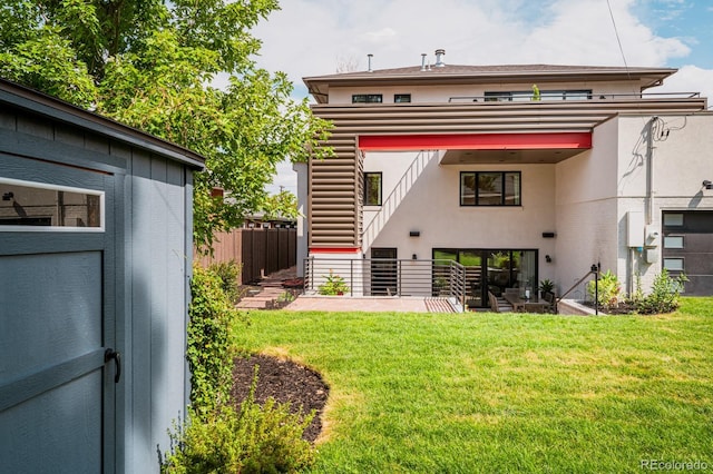 rear view of property with a yard and a patio