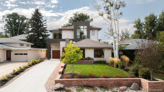 view of front of home with a garage and a front yard