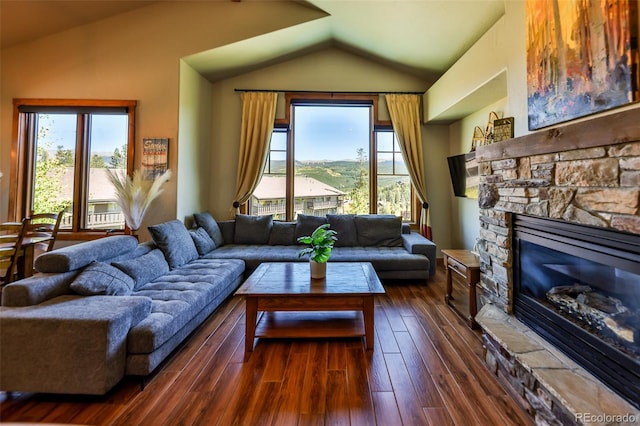 living room featuring a fireplace, dark wood-type flooring, and lofted ceiling