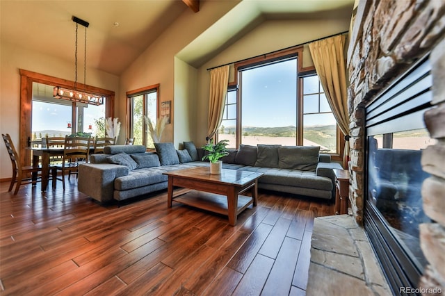 living room featuring vaulted ceiling with beams, dark hardwood / wood-style flooring, and a wealth of natural light