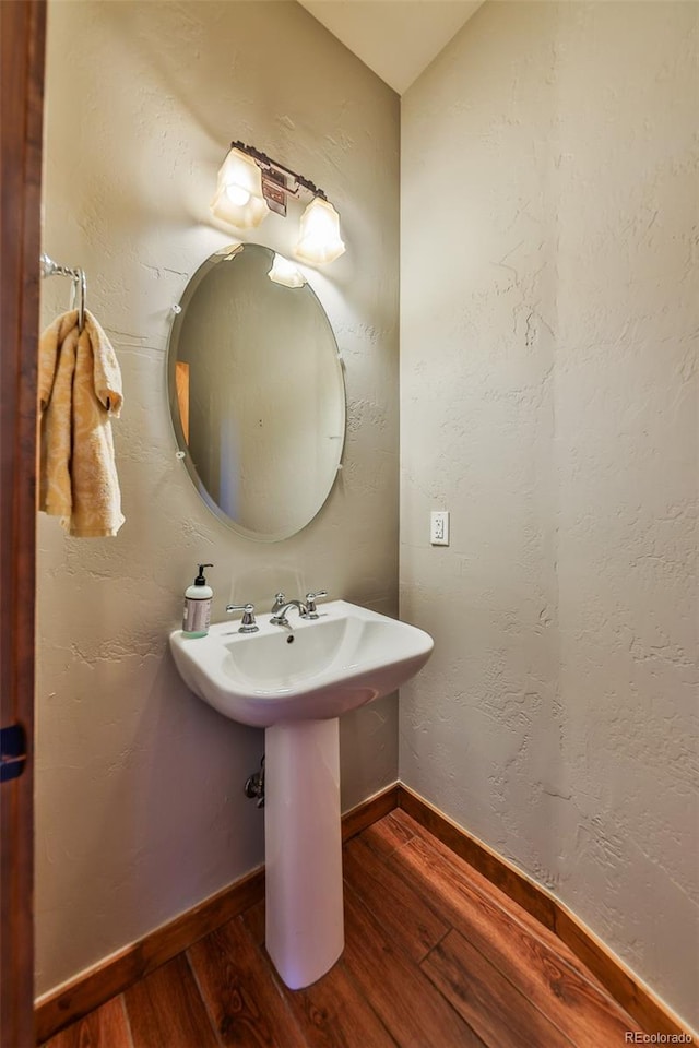 bathroom with hardwood / wood-style flooring