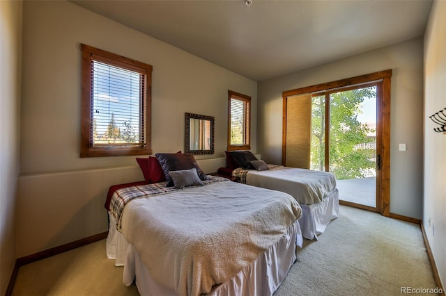 carpeted bedroom with access to exterior and multiple windows